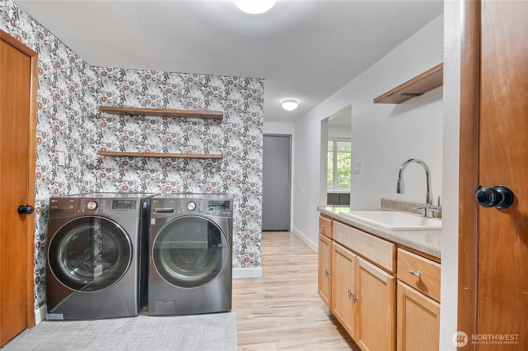 Laundry room with staircase to private guest quarters w/ 2 bedrooms, great room & micro kitchen