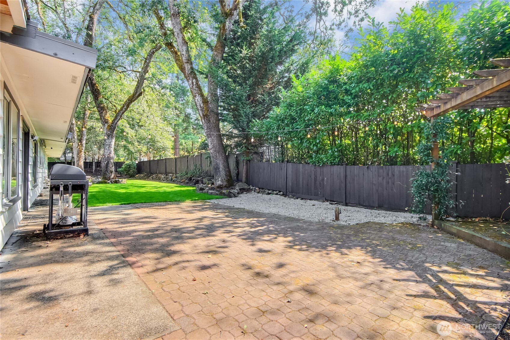 Fenced backyard with sprinkler system.