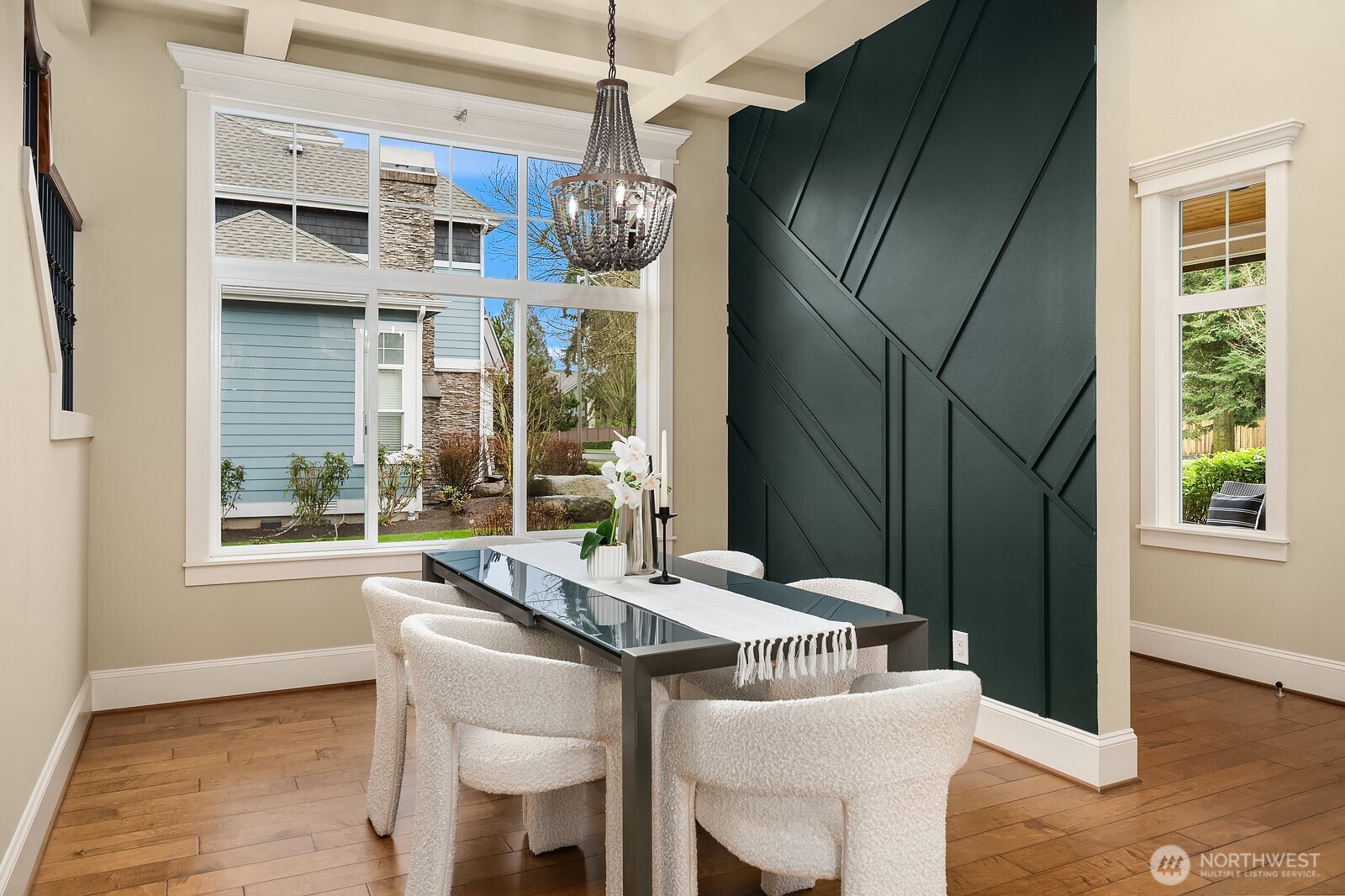 The formal dining room makes a bold statement with a dramatic accent wall, elegant chandelier, and rich hardwood floors — a sophisticated and stylish space perfectly suited for memorable dinner parties and holiday gatherings.