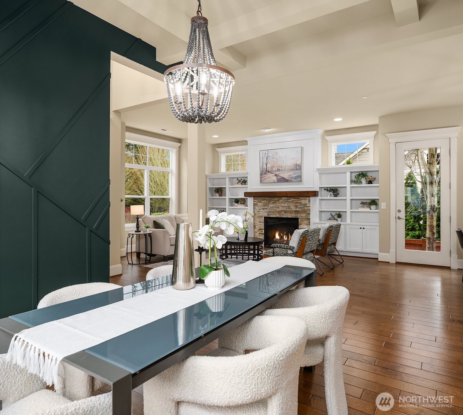 Another angle of the dining room showcases the stunning accent wall, elegant chandelier, and seamless connection to the living room beyond — a beautifully designed space that is as functional as it is visually striking.