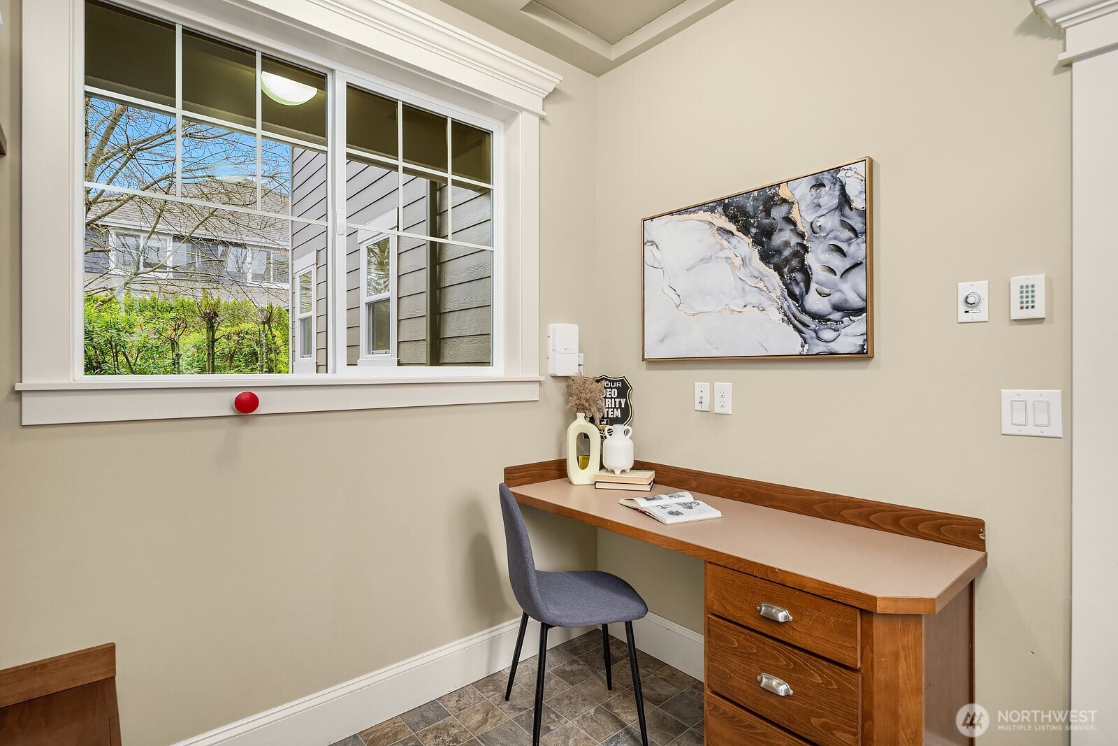 A charming built-in desk nook offers a quiet and dedicated workspace, tucked away with a bright window and warm wood tones — a thoughtful detail that adds everyday functionality to this well-designed home.