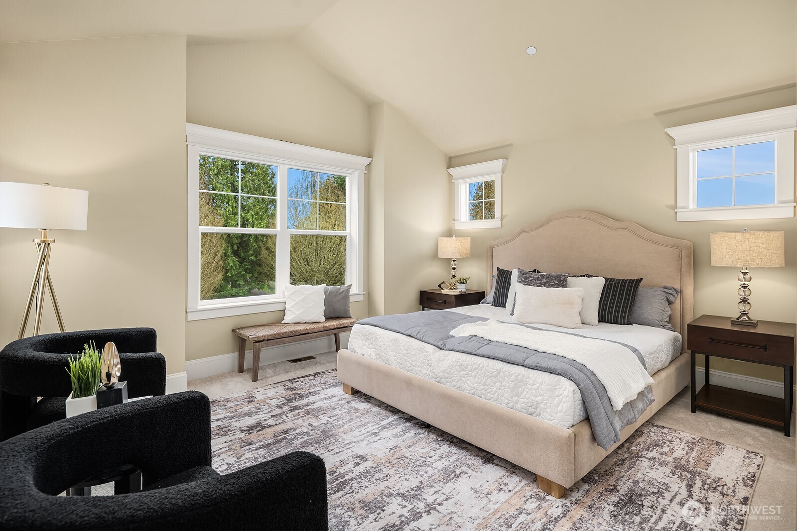 The serene primary suite is a true retreat, offering a spacious and light-filled layout with large windows, warm neutral tones, and ample room for a generous furniture arrangement — a peaceful haven at the end of every day.