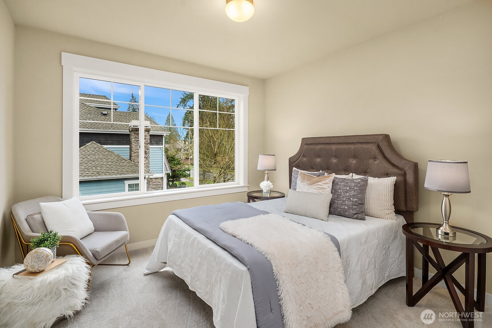 One of the generously sized secondary bedrooms offers a bright and comfortable retreat with a large window, soft neutral tones, and plenty of space — ideal for guests, family, or a dedicated home office.