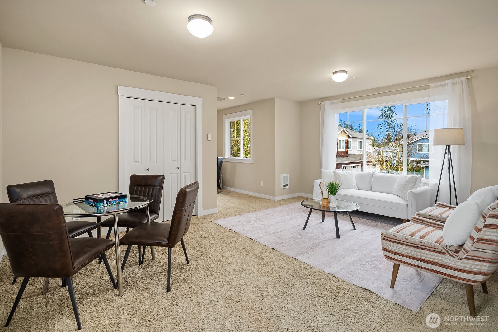The bright and versatile ADU living area offers a comfortable and functional open layout with a dining space, large window, and a separate entrance — an ideal setup for rental income, guests, or multigenerational living.