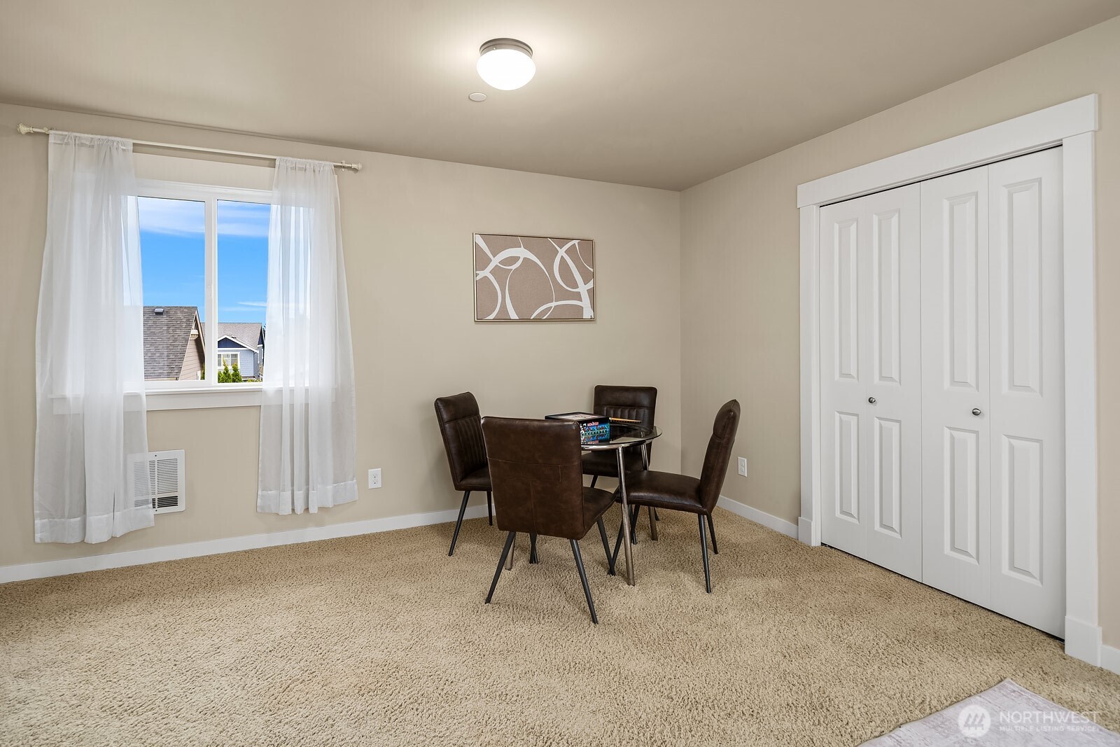 The ADU's dining area offers a functional and comfortable space with a bright window and convenient closet storage — a thoughtfully designed layout that makes this self-contained unit as practical as it is livable.