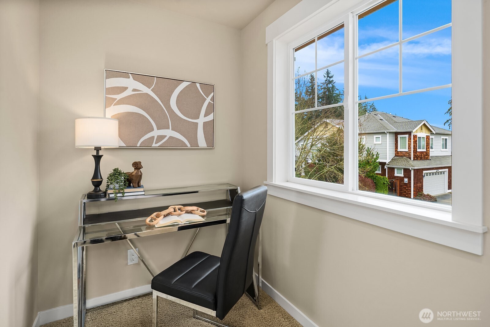 The ADU's private bedroom doubles beautifully as a home office, featuring a bright window with lovely neighborhood views and a clean, versatile layout — a comfortable and functional space within this exceptional above-garage unit.