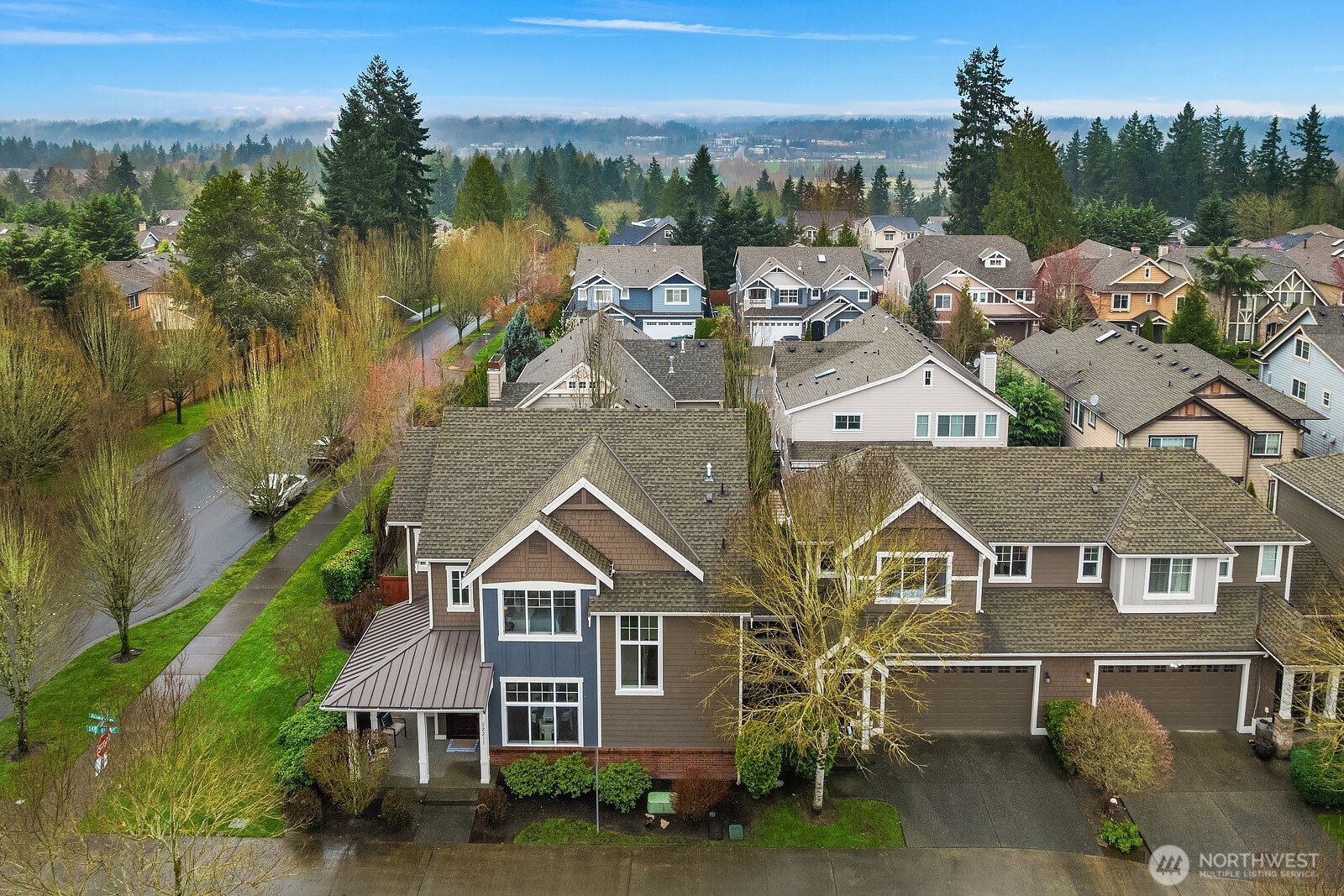This aerial view showcases the home's desirable corner lot position within the Sycamore Park neighborhood, highlighting the classic Craftsman architecture, private yard, and the well-established, tree-lined community setting.