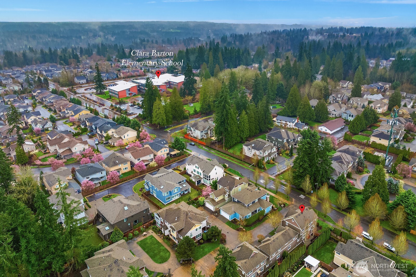 A sweeping aerial perspective showcases the home's prime English Hill location, nestled within a vibrant and well-connected Redmond community surrounded by mature trees, parks, and convenient access to everything the Eastside has to offer.