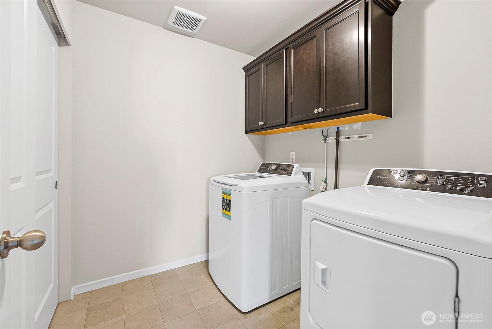Upstairs Laundry with large linen closet and cabinets