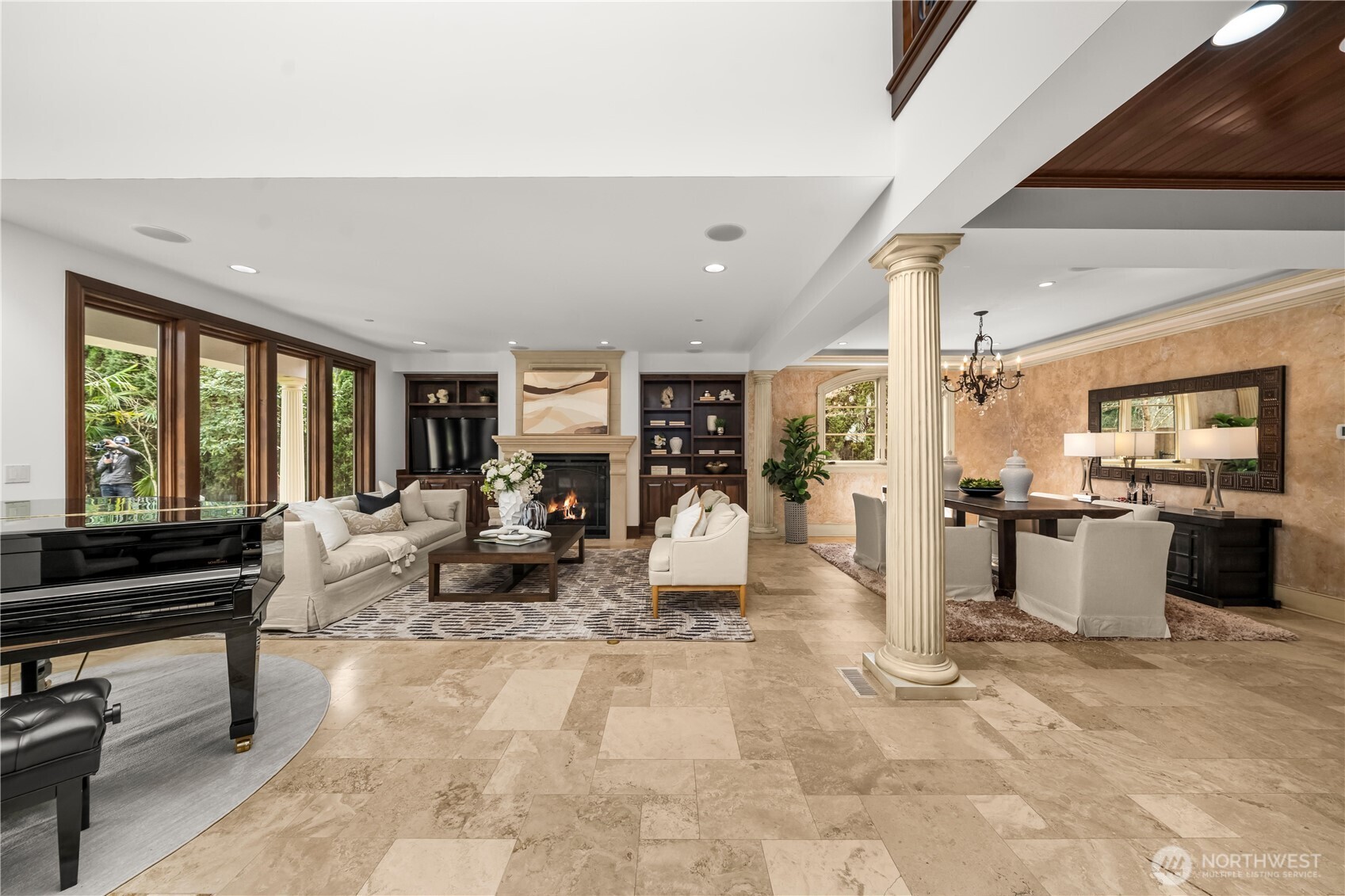 Grand, open-concept living and dining areas defined by architectural columns, rich finishes, and effortless indoor-outdoor connection.