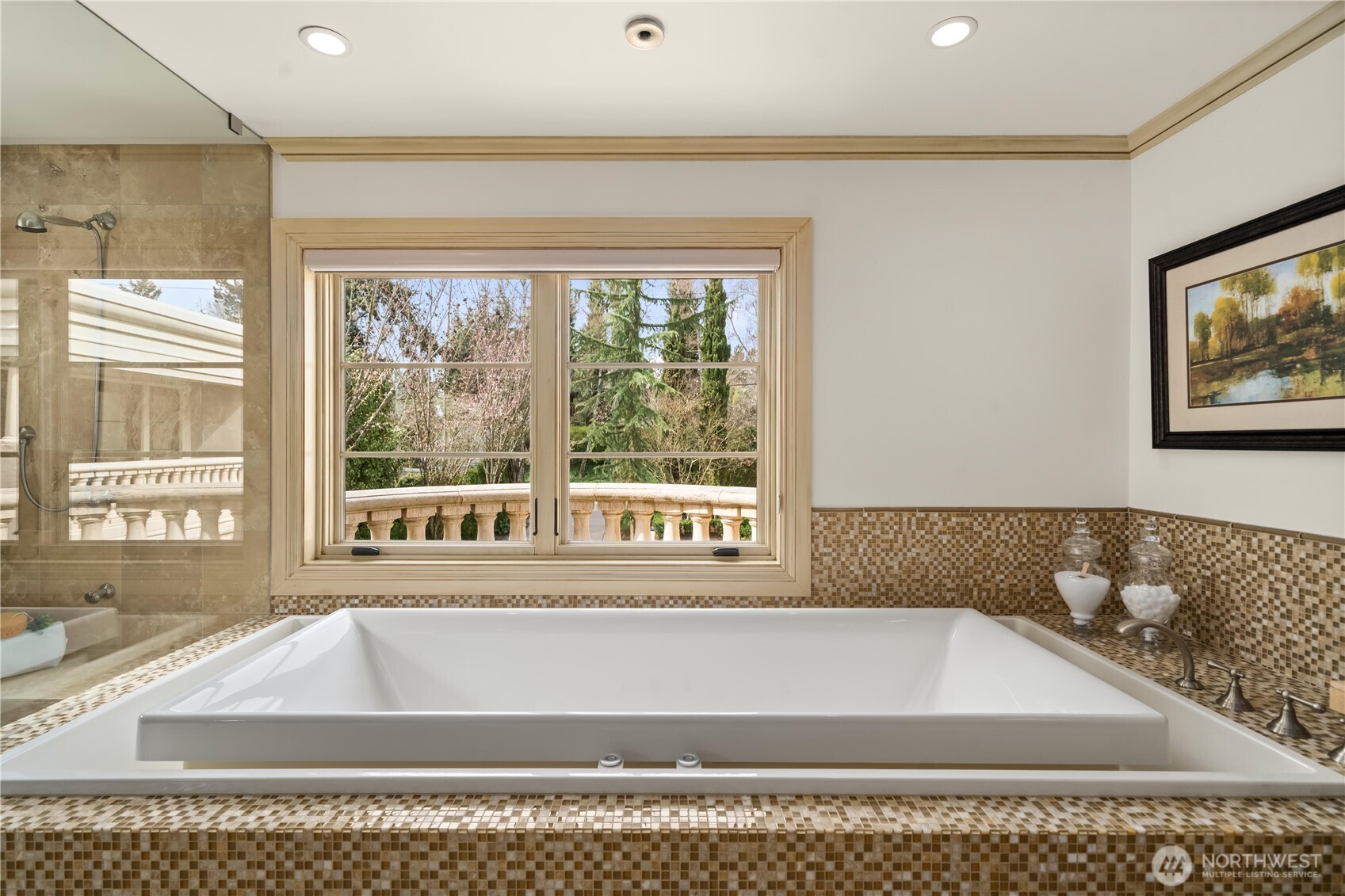 Spa-inspired primary bath featuring a walk-in shower, soaking tub, dual vanities, and refined stone finishes.