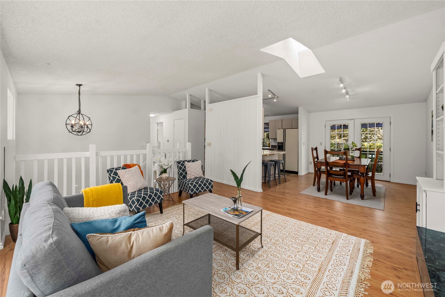 Plank flooring continues into the dining space.