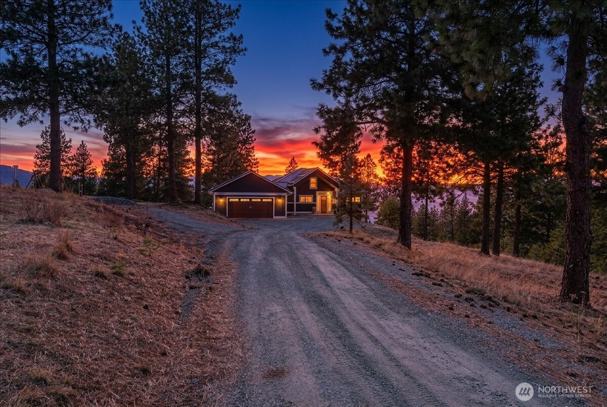 Twilight view of driveway leading to subject property