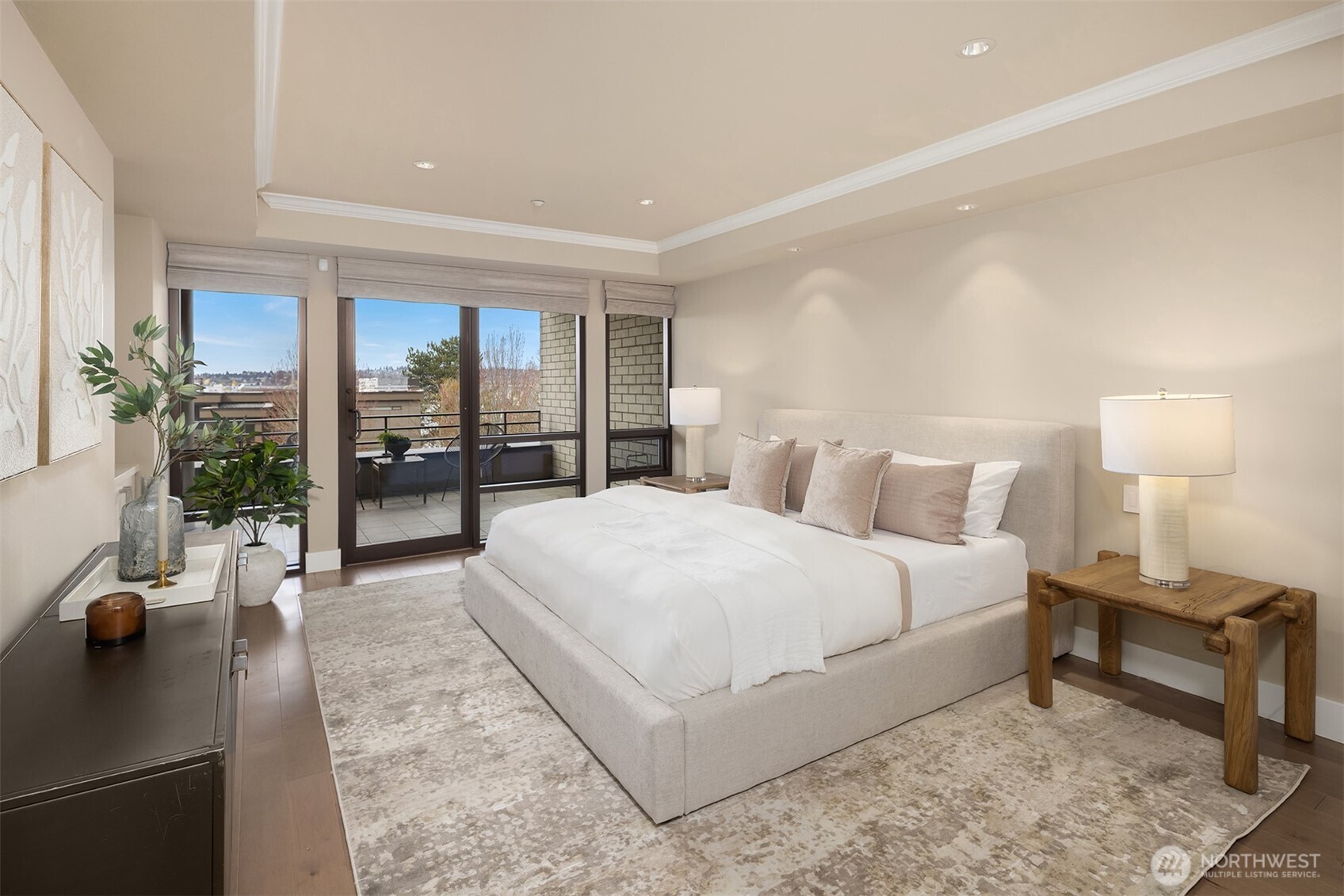 The spacious primary suite offers a spa-like escape with heated floors, a generous marble shower with bench, and refined finishes throughout.