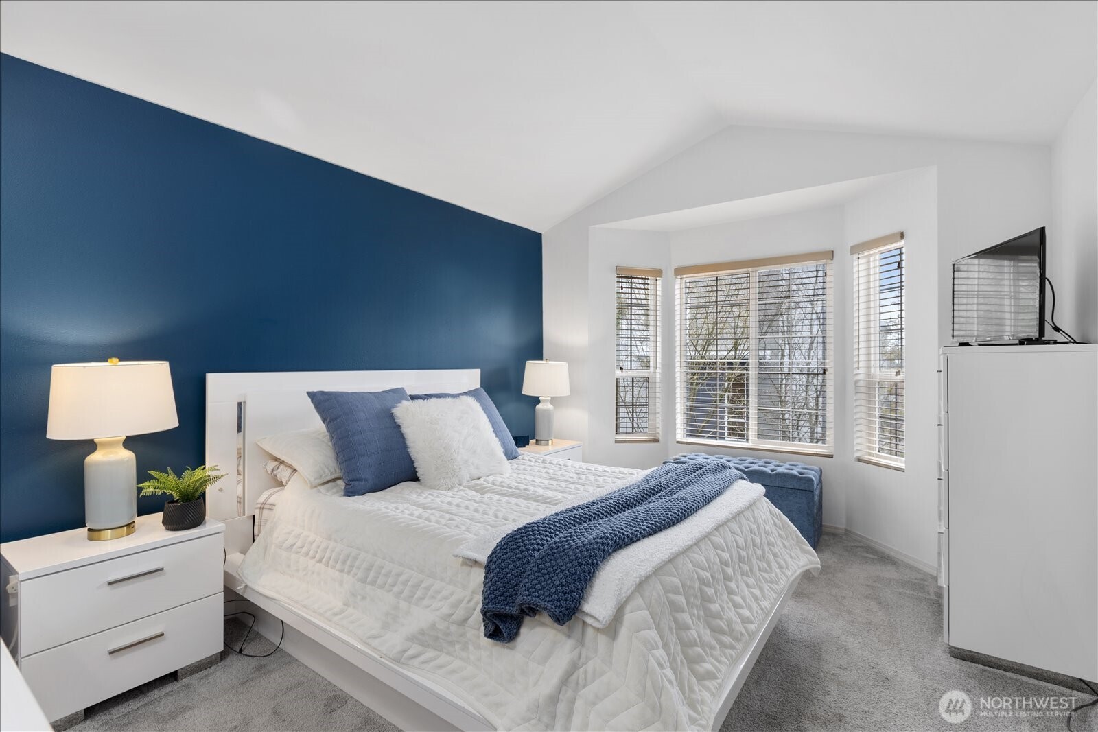 Primary Bedroom with vaulted ceilings and lots of natural light.