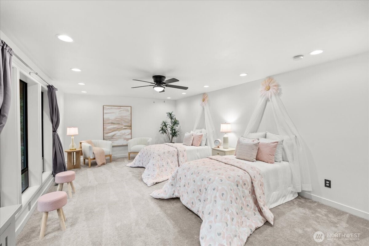 Another spacious bedroom comfortably accommodates two twin beds while maintaining plenty of open floor space for play or activities.