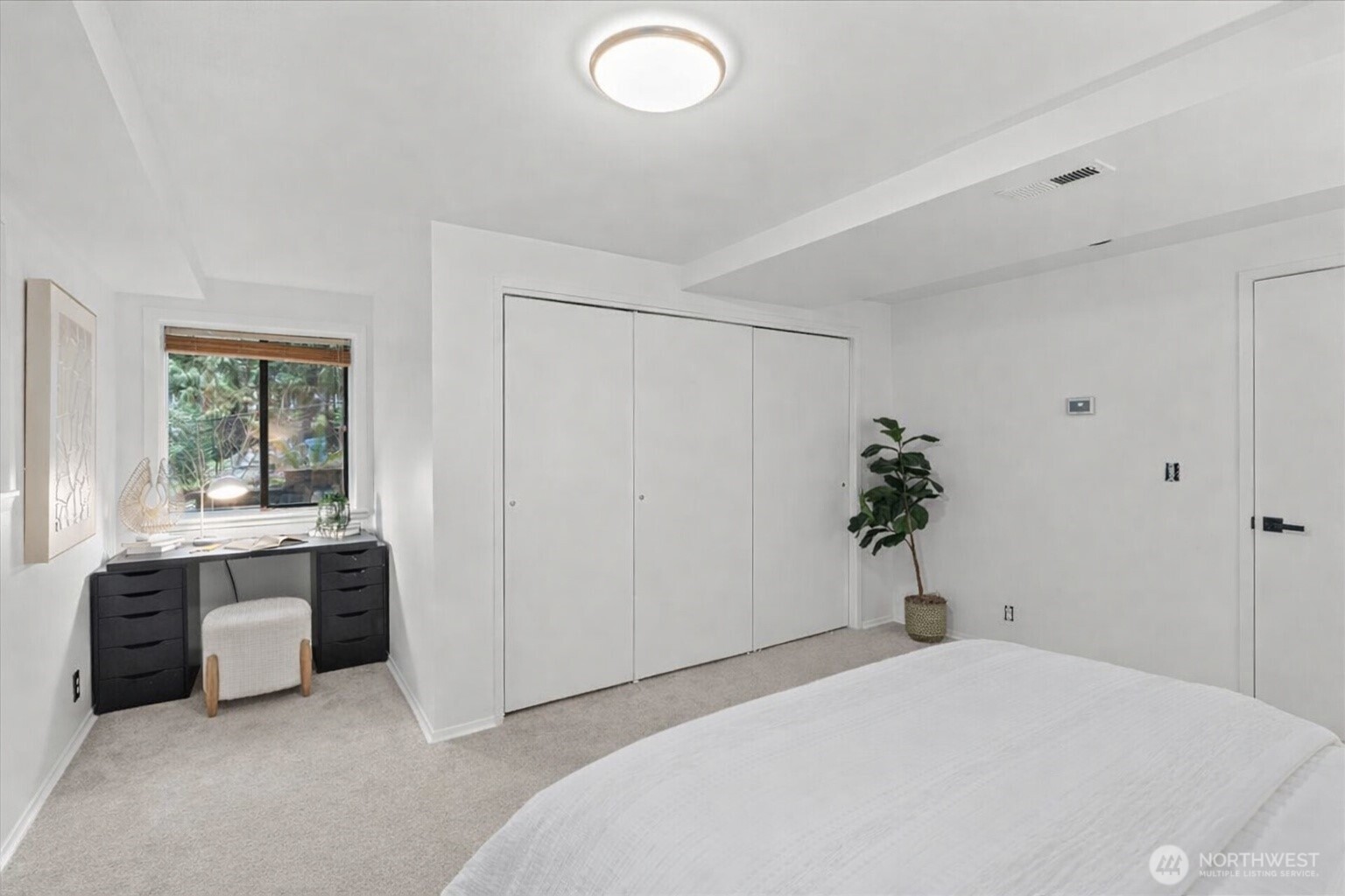 This bedroom features a charming nook, ideal for a work desk or cozy reading chair.