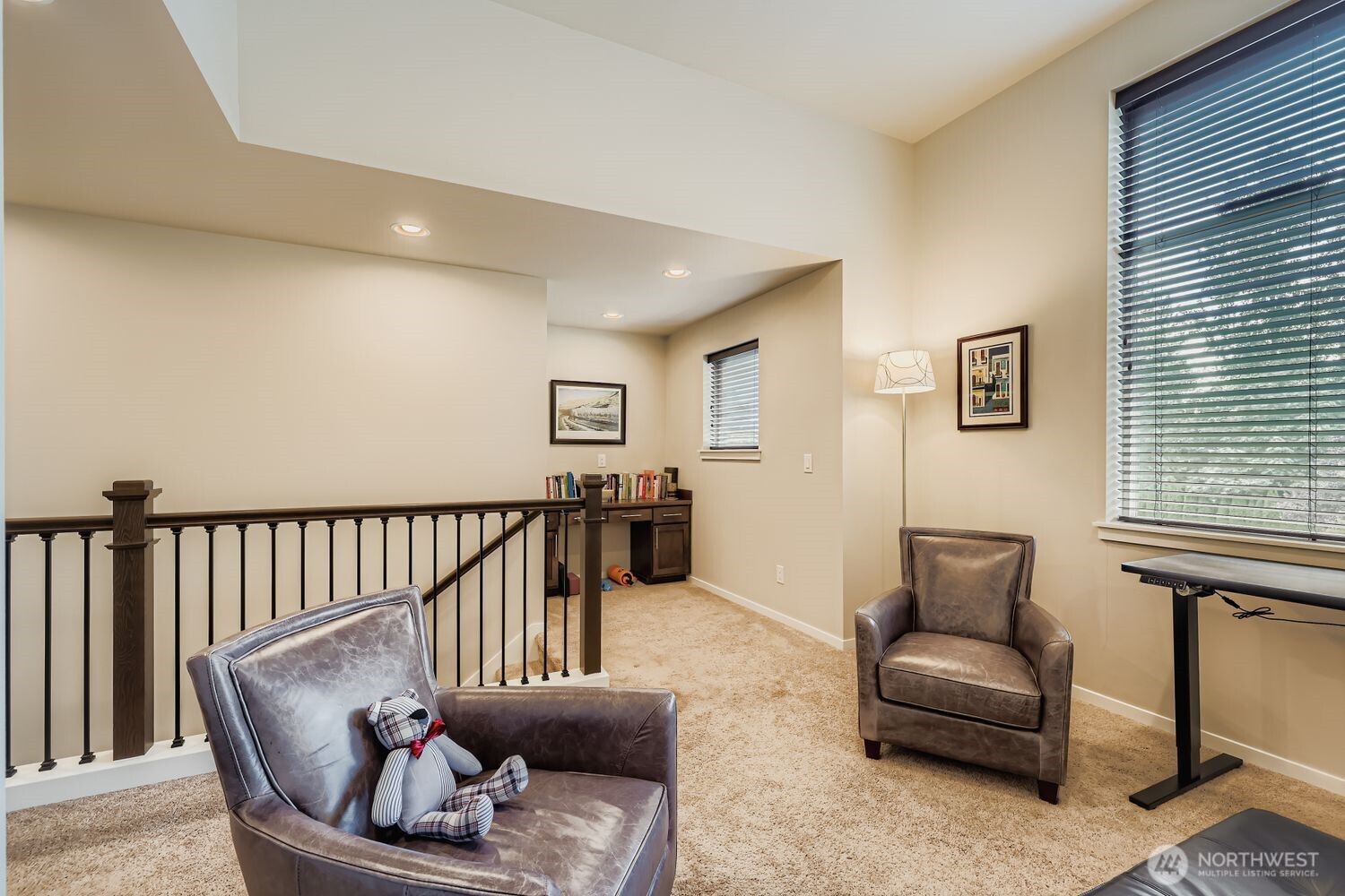 loft area open to work space with desk.