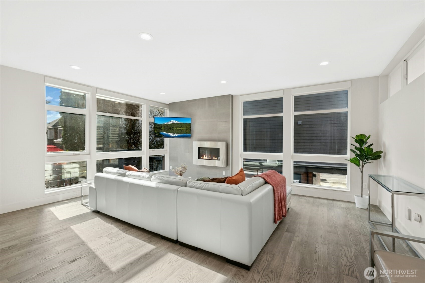 Light-filled living room with dramatic floor-to-ceiling windows