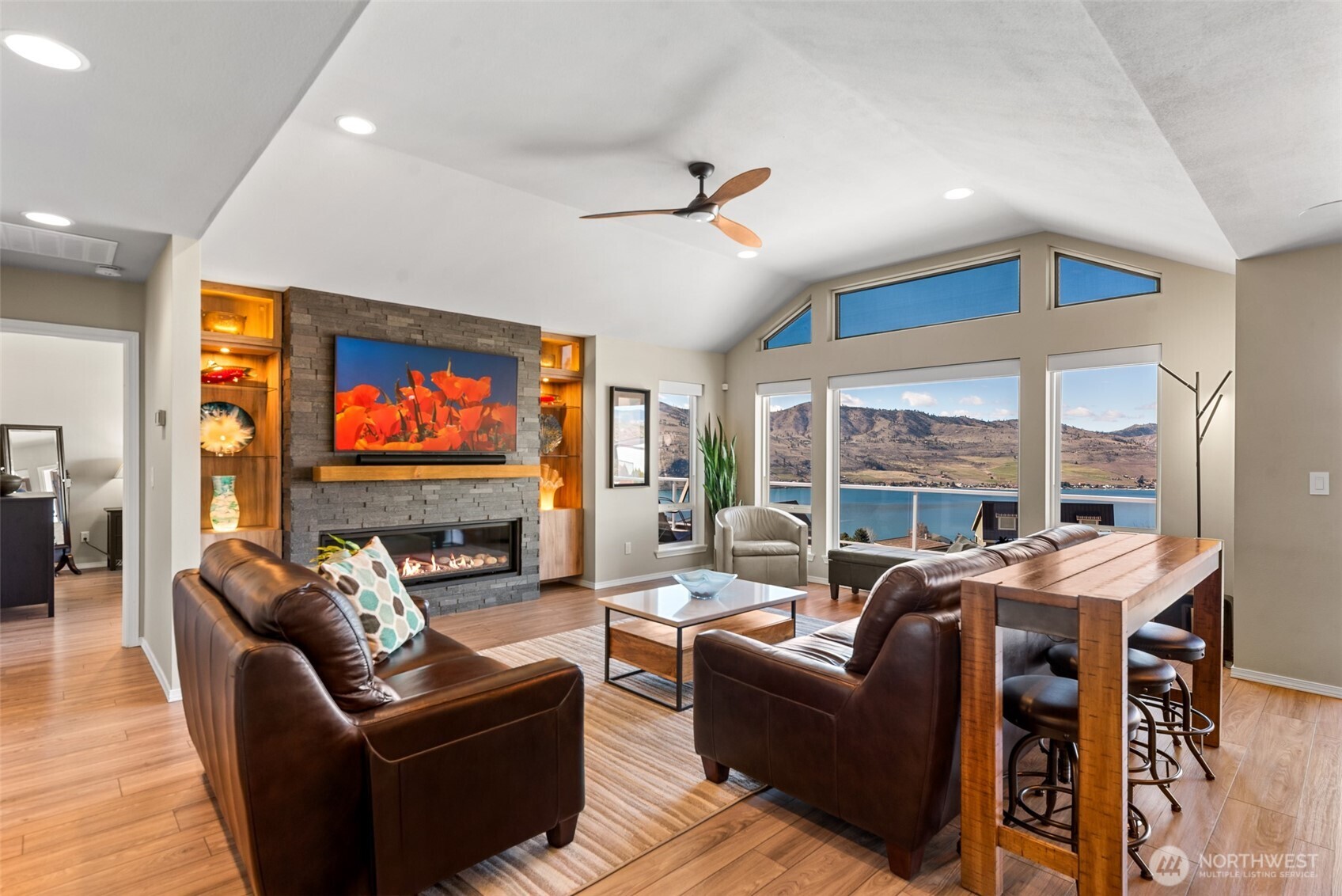 The great room showcases spectacular views, with a vaulted ceiling that adds volume and a grand sense of space.