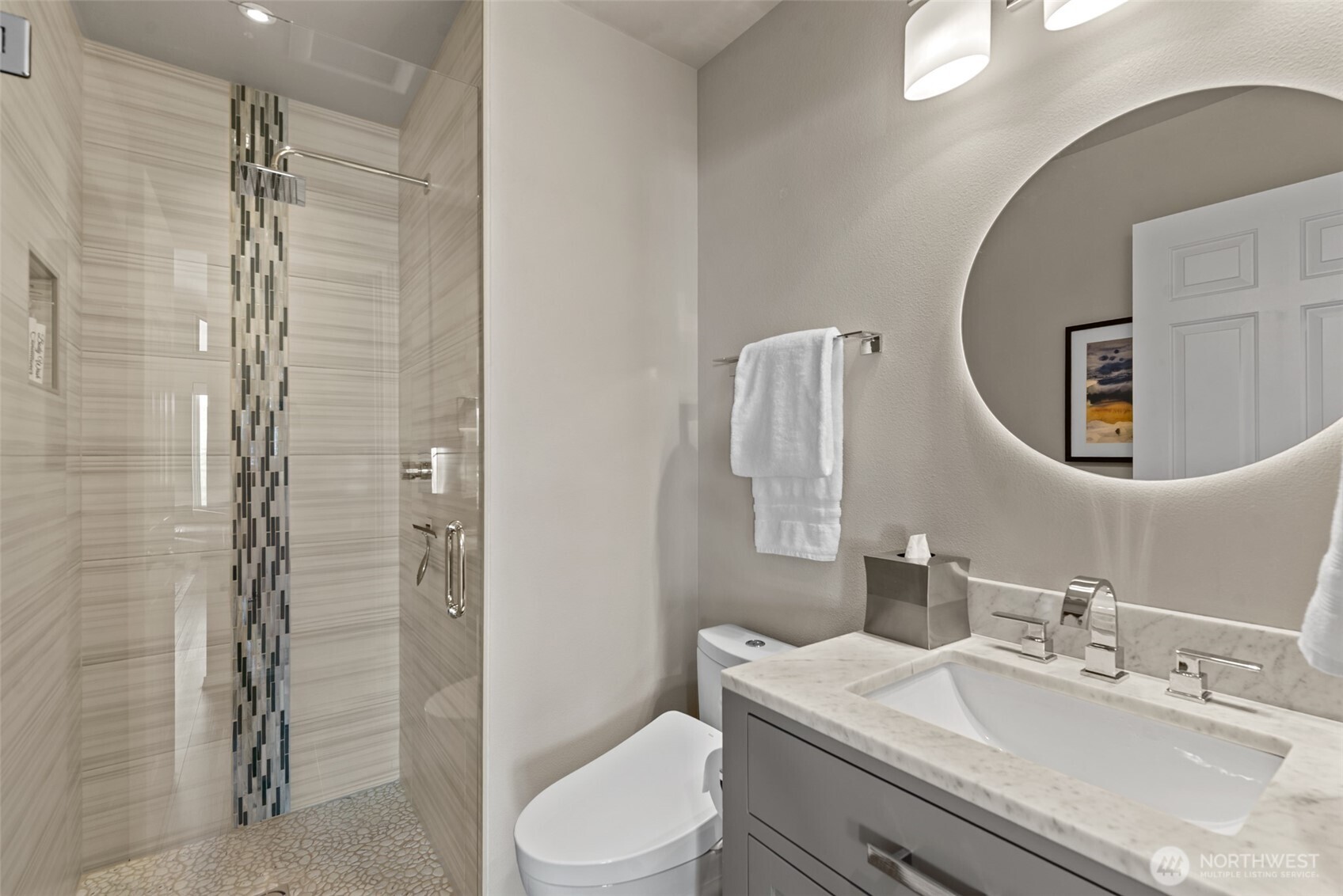 Beautifully remodeled upper level 3/4 bathroom with a stunning tile shower located near the office.