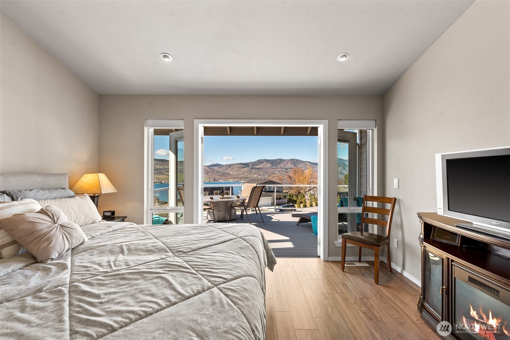 How about a room with a view? Take in beautiful Lake Chelan and mountain scenery from the French doors with side panels in the primary suite, which easily accommodates a king bed.