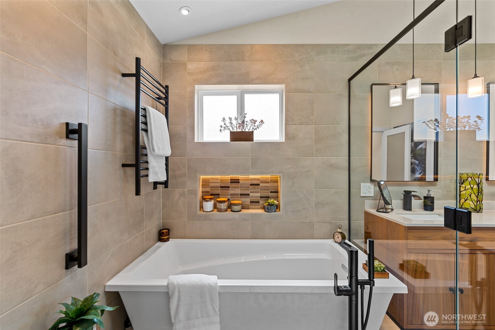 Luxury primary bathroom with heated towel racks, dual shower heads, and a deep soaking tub for ultimate comfort and relaxation.