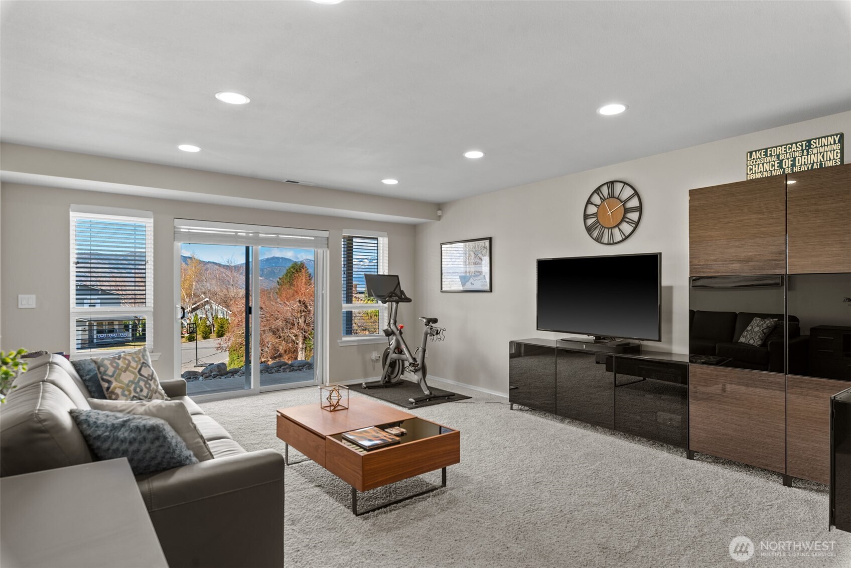 Family room sliders open to a full-length covered patio, ideal for indoor-outdoor living in this Lake Chelan view home.