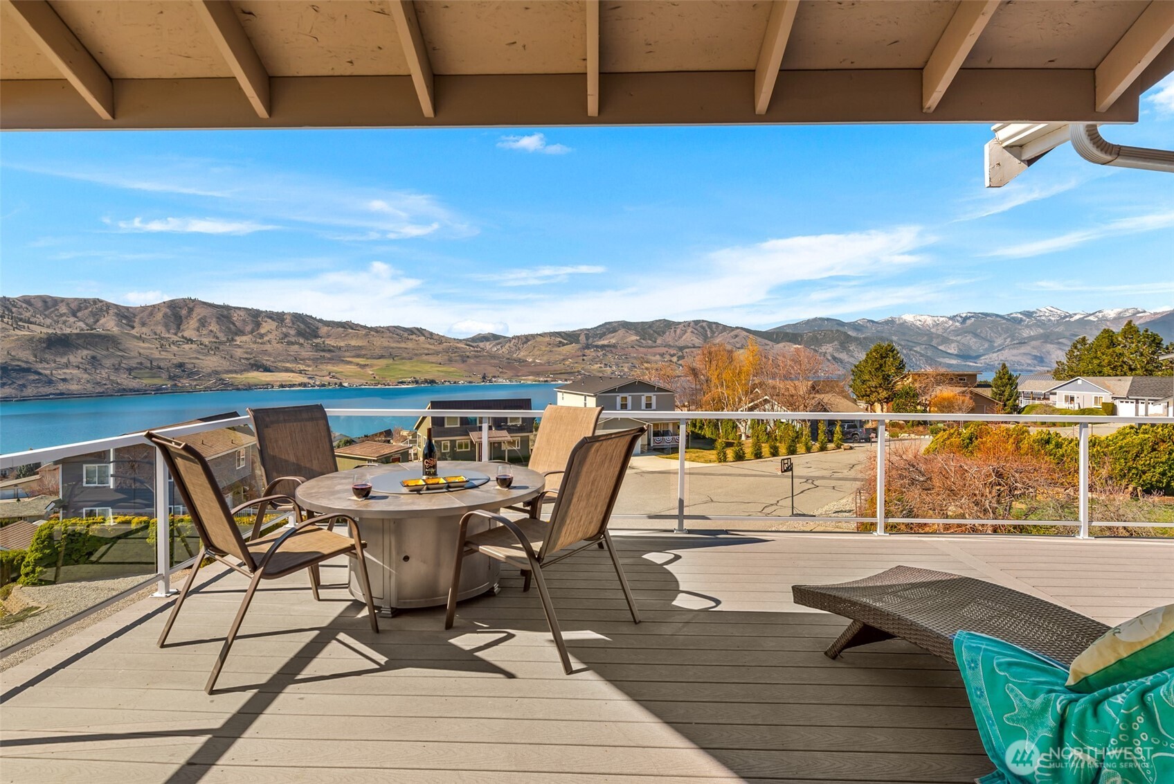 This spacious view deck is ideal for lounging or entertaining after a day at the Lake Chelan Hills parks, waterfront, and community pools. The propane-plumbed fire table is included in the sale.