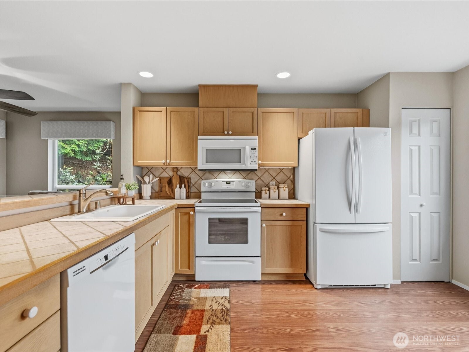 Kitchen features pantry storage and large window