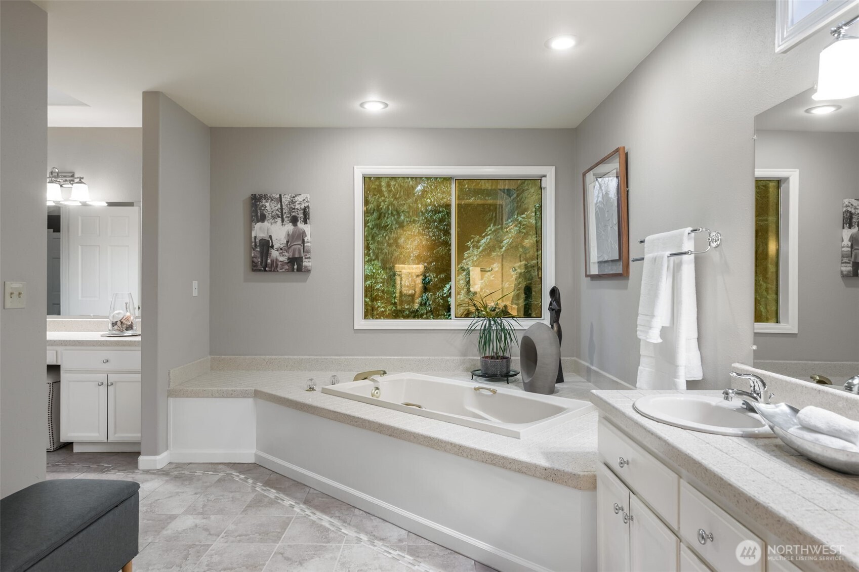 Corner soaking tub with separate tile shower.