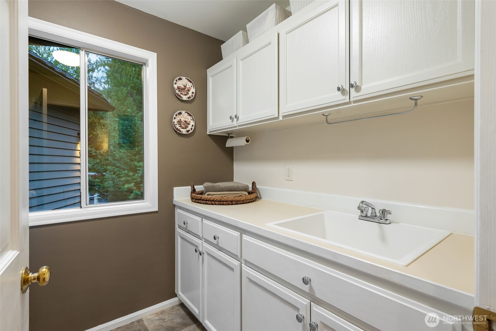 Main floor laundry room with painted cabinets & new sink.
