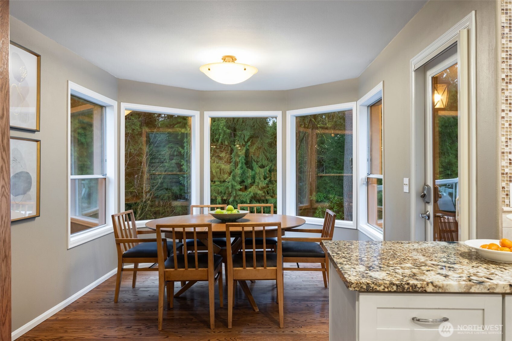 Spacious eat-in kitchen nook leads to upper outdoor deck.