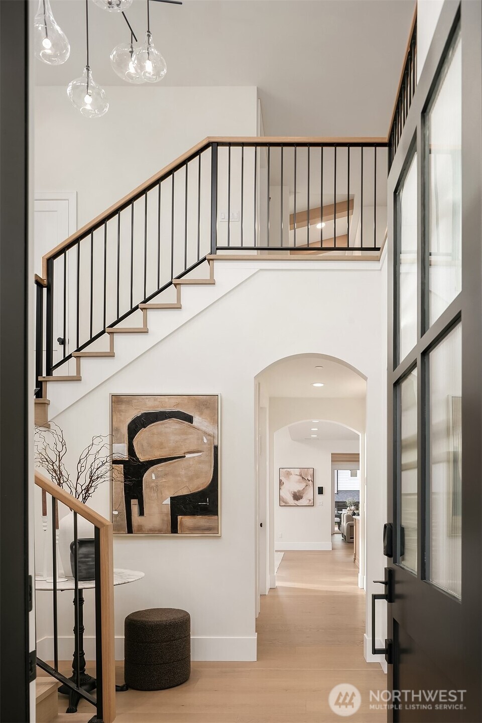 Grand entryway featuring over 18 foot ceilings and an open, airy layout that sets the tone for the home’s elevated design.