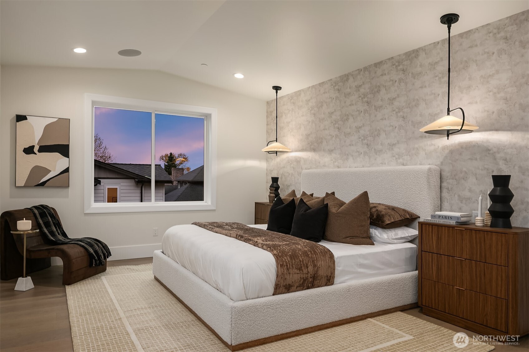 ight-filled primary bedroom highlighted by designer pendant lighting and a spacious layout.