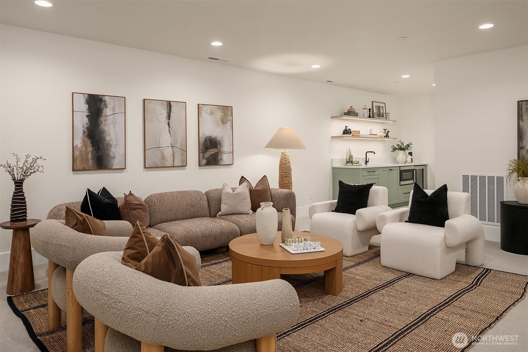 A generous lower-level bonus room designed for entertaining, featuring ample space for lounging, games, or a home theater setup.