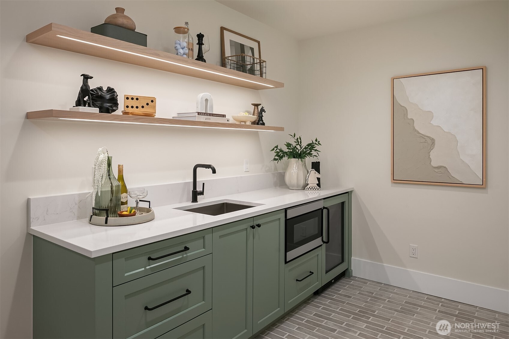 Entertaining made easy in the bonus lounge with a built-in wet bar featuring custom cabinetry, open shelving, a microwave, and a sleek beverage fridge.