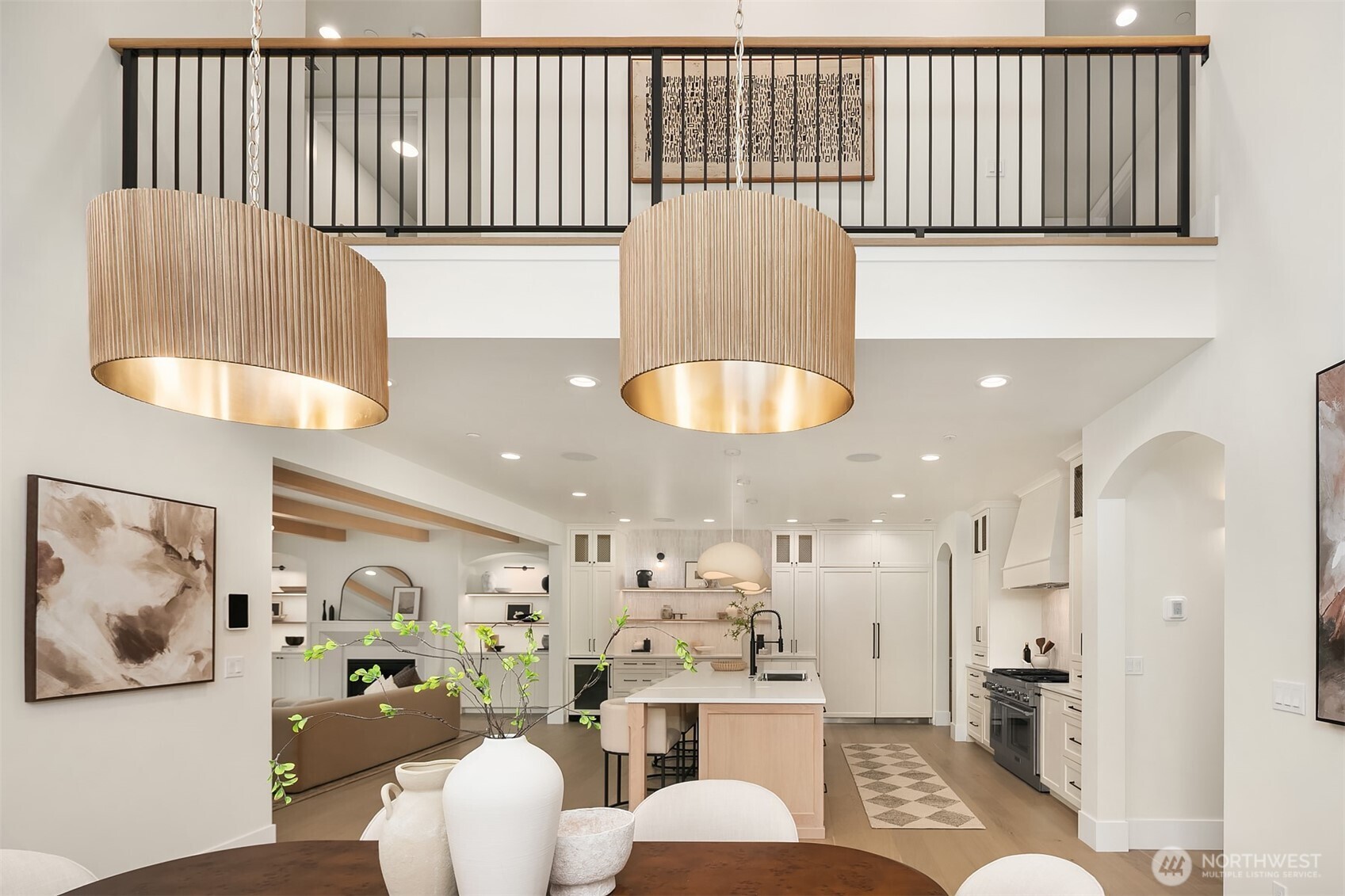 Spacious open-concept layout connecting the kitchen island and dining area, designed for easy gathering, entertaining, and everyday living.