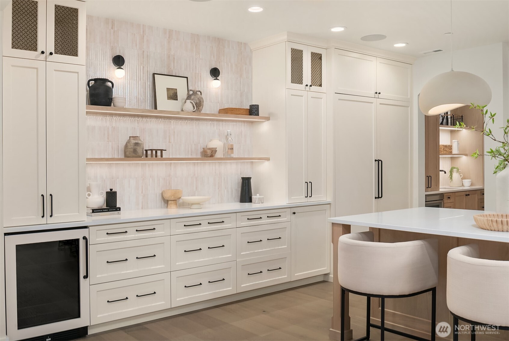 ustom cabinetry wall featuring a built-in, panel-ready refrigerator, open shelving, and integrated storage for a polished, uninterrupted kitchen aesthetic.