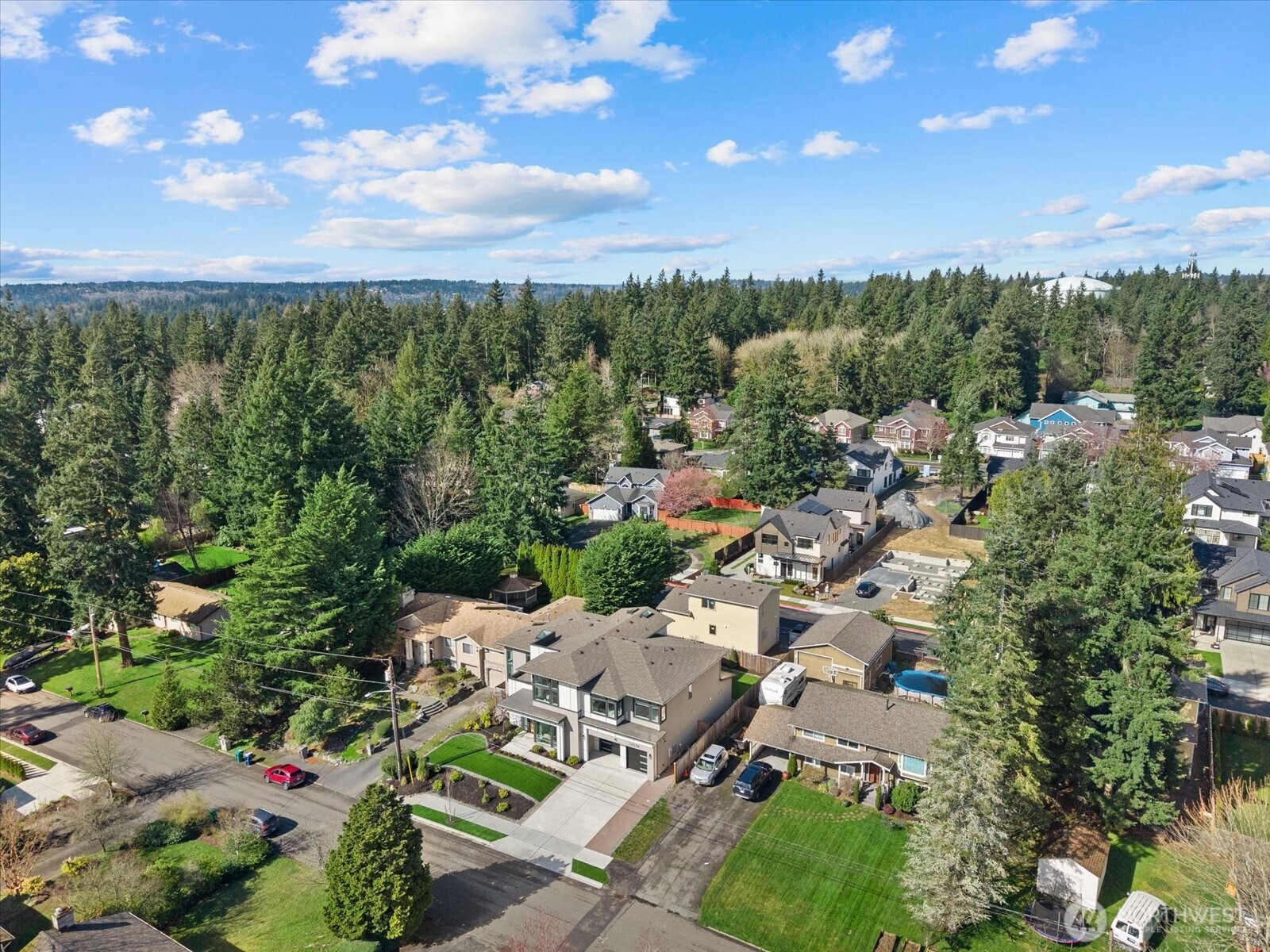 Nestled into a lush Kirkland setting surrounded by mature evergreens, this residence offers a rare balance of modern architecture, neighborhood charm, and everyday privacy.