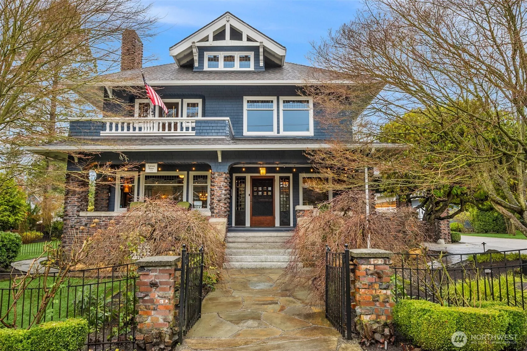 A timeless Craftsman presence anchors the heart of downtown Snohomish. Bathed in twilight glow, this iconic façade showcases classic proportions, deep overhangs, brick detailing, and a welcoming front porch—an unmistakable landmark with enduring architectural gravitas.