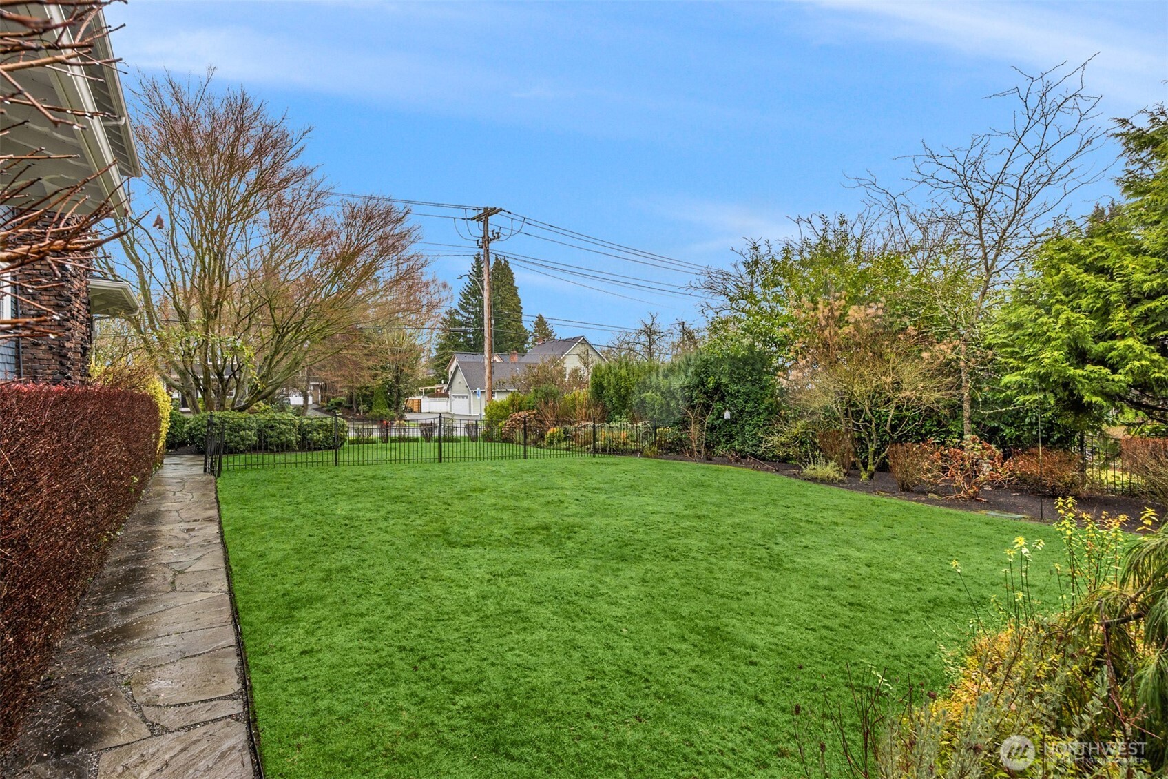 A level, fully enclosed lawn offers rare green space in downtown Snohomish, surrounded by established landscaping that provides both privacy and beauty.