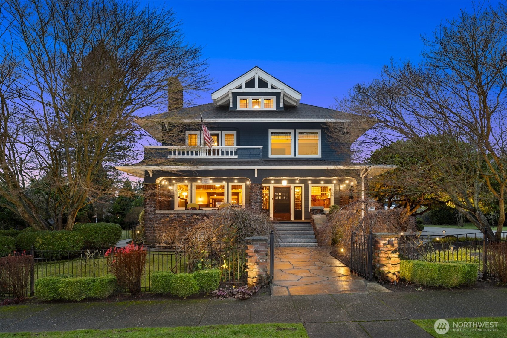 The Iverson House's Craftsman façade is rich in character, blending shingle siding, brick detailing, and balanced proportions that anchor it as a true downtown landmark.
