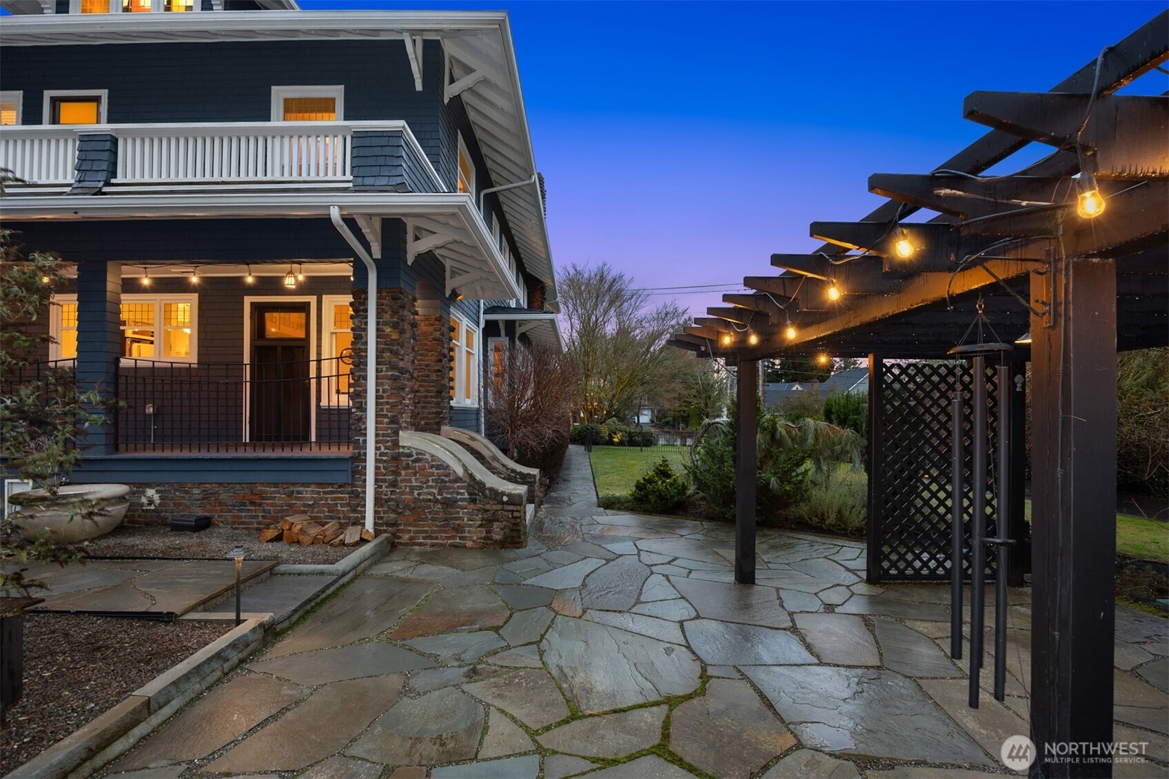 A private garden courtyard invites connection and calm. Stone pathways, ambient lighting, and a pergola-draped outdoor living space create an intimate retreat—perfect for evening gatherings, quiet moments, or seamless indoor-outdoor entertaining.