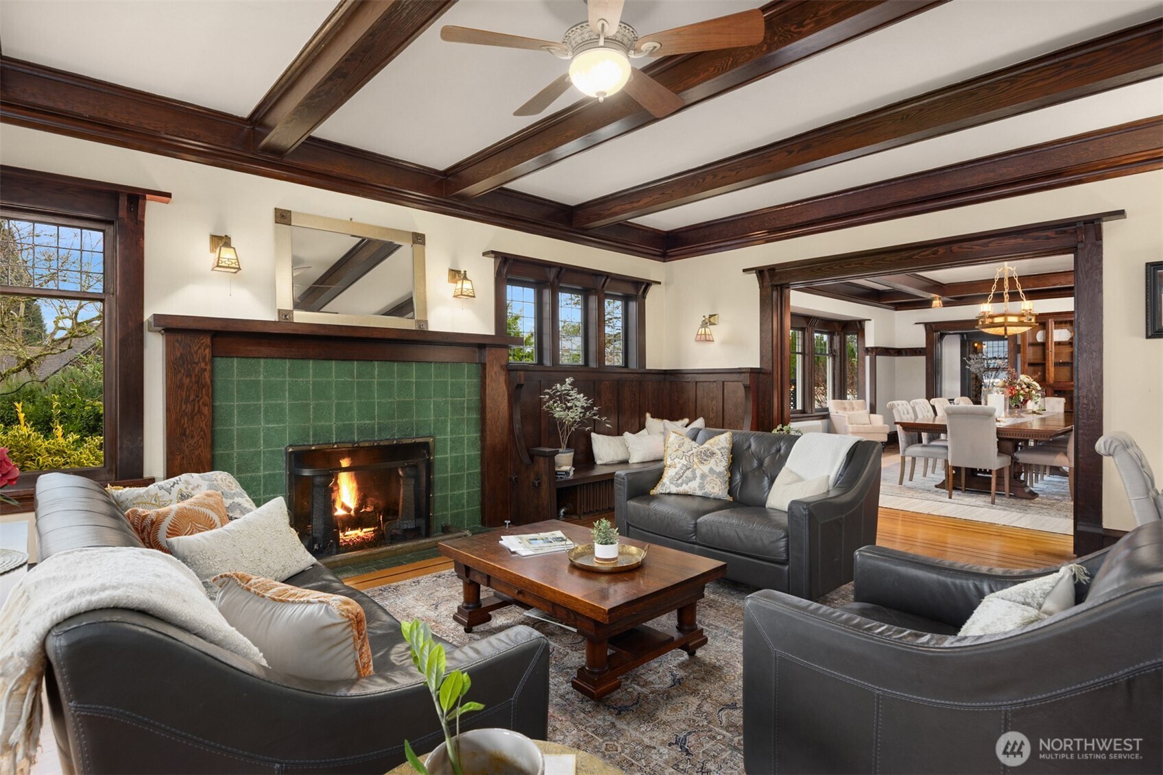 Intimate yet expansive, the main living area showcases built-in seating, artisan woodwork, and period lighting, flowing effortlessly into the formal dining room—an ideal setting for gatherings that feel both refined and warmly personal.