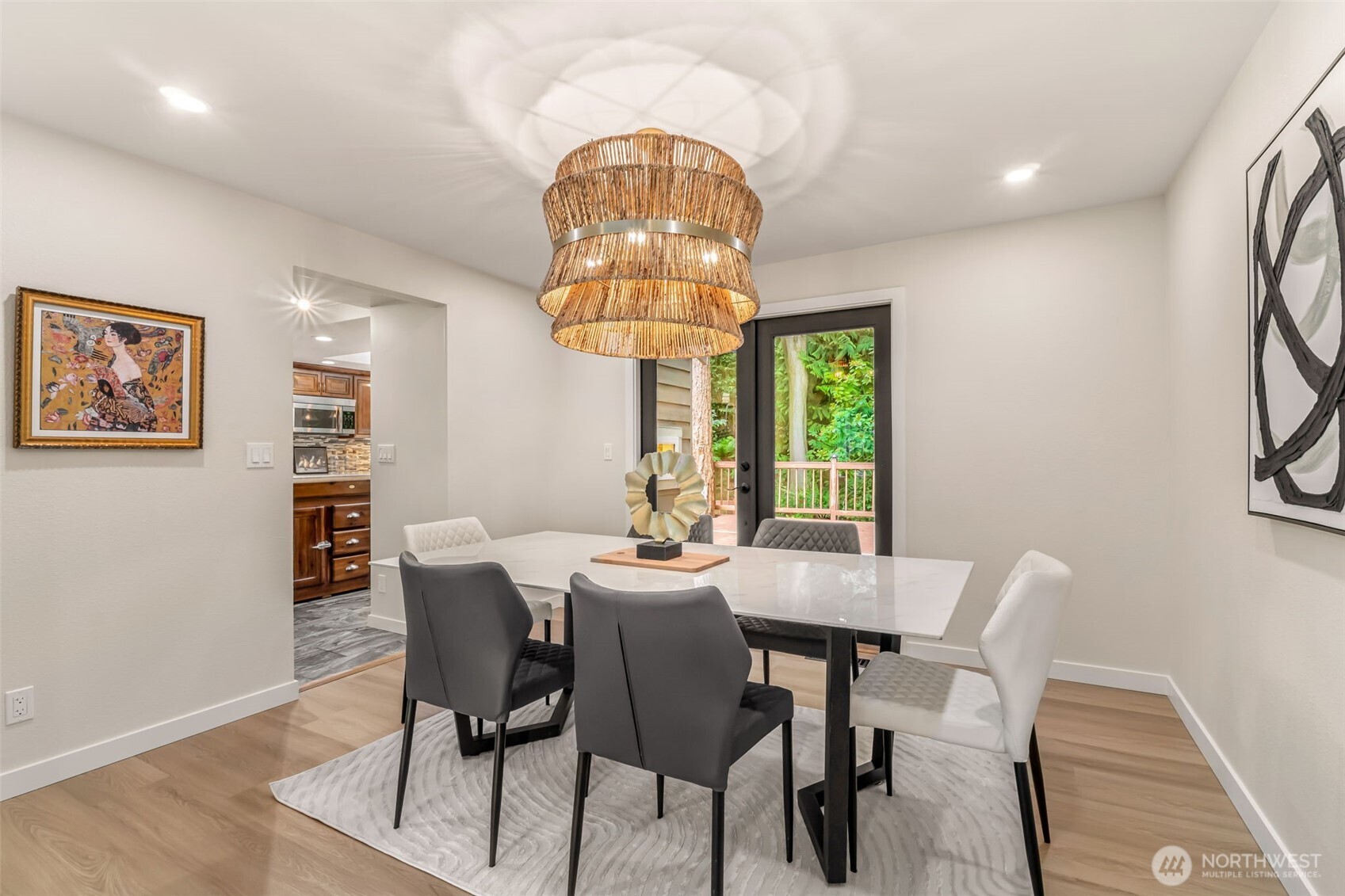 Formal dining leads right to an expansive deck, that was built around a tree!
