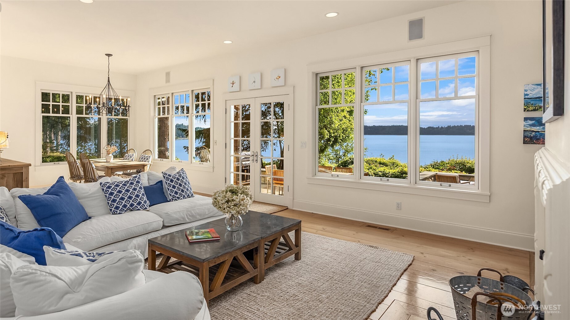 Bright family room and formal living room, both with Rumford fireplace, abundant  windows and French doors to the back patio.