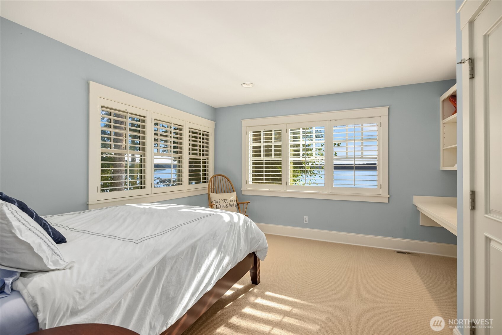 West side bedroom with built in desk and storage.