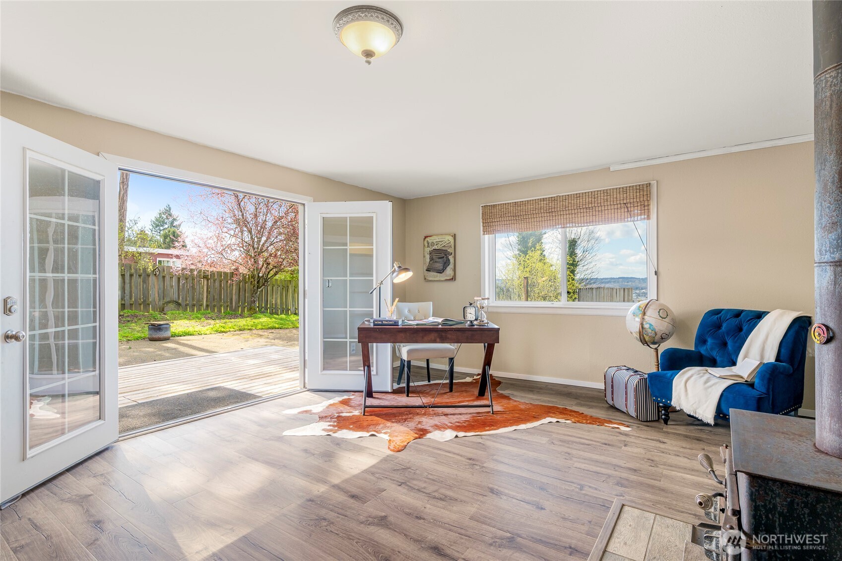 Third bedroom, office space, or bonus room opens to the deck with hot tub behind the home