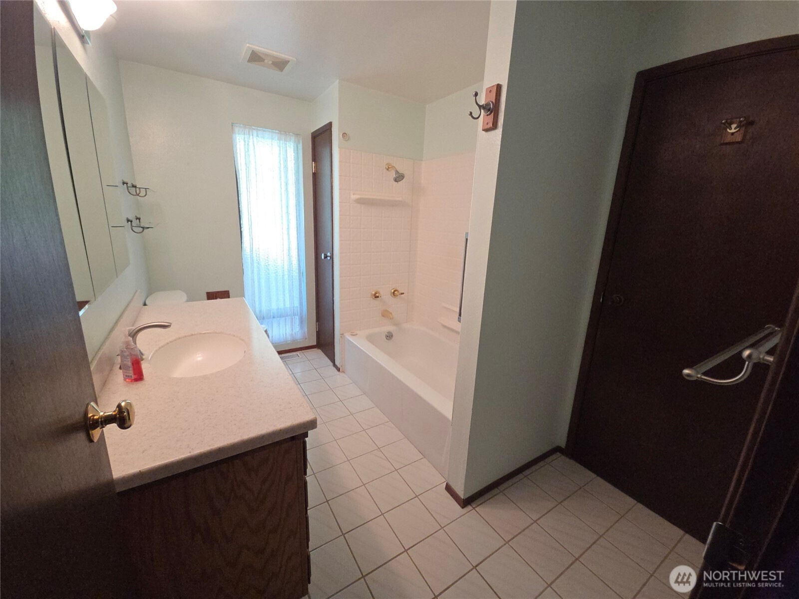 Spacious bathroom with door leading to the primary